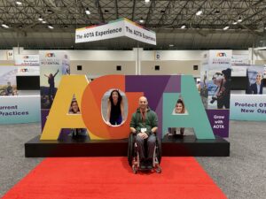 At the AOTA conference by the big AOTA sign