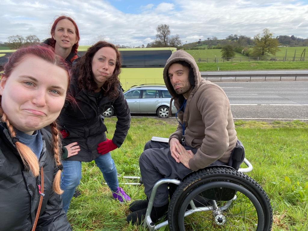 Sad faces from the team as we sit on the side of the motorway with a flat tyre.