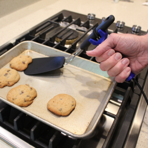 functional hand holding spatula to pick up cookies
