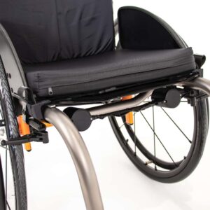 LapStacker positioned under the seat on a manual single tube frame wheelchair