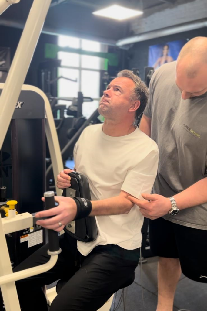 A man uses our looped aids on an exercise machine