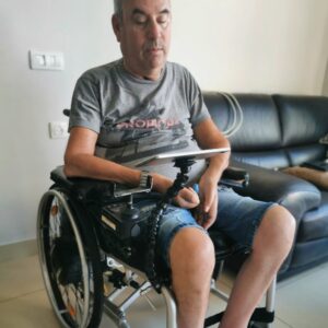 Customer, Ziv Goren, uses the Flexi Phone Holder to support his iPad while using his wheelchair