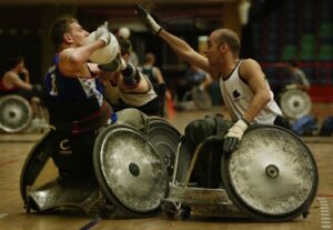 Two wheelchair rugby players fighting for the ball