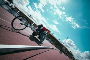 Wheelchair racer on the track against a blue sky