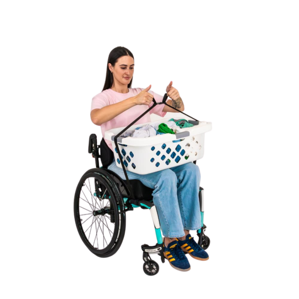 Lady in wheelchair with a basket of washing on her lap, using a LapStacker to secure it in place