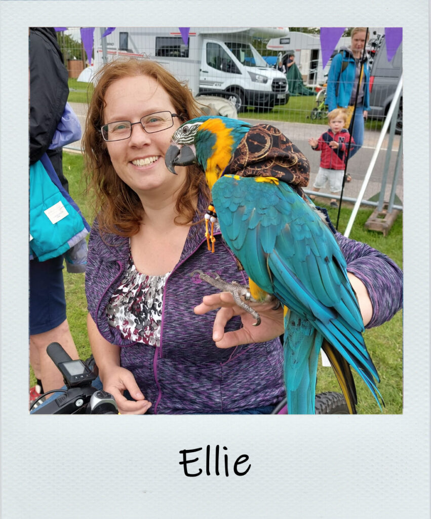 Woman with blue parrot on her arm