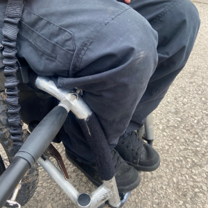 Close up of wheelchair dog lead attached to chair