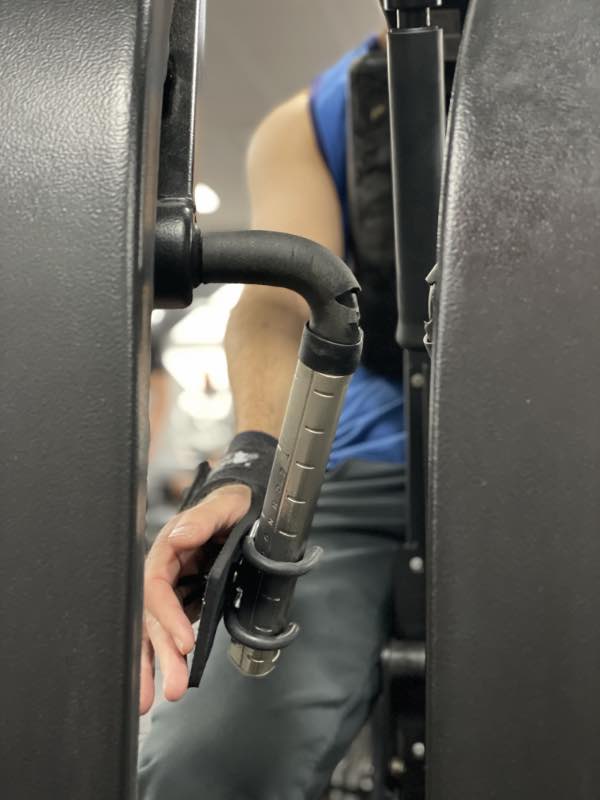 a close up of a hook aid on the handle of a row machine at the gym