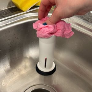 To squeeze the water from your dishcloth, put it into the top of the tube.