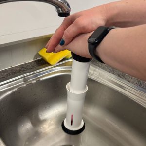 Insert the plunger and press down to remove water from the cloth