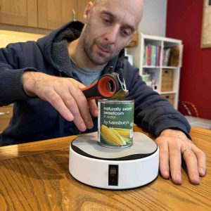 image shows rob opening a ring pull tin using the hold fast platform to hold the tin steady.