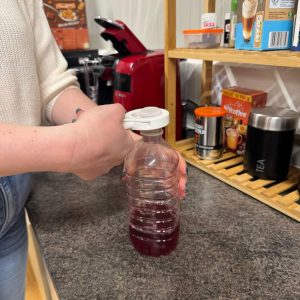 Squeeze the cap off and twist to remove a lid