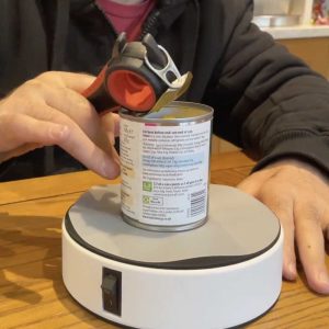 image shows a ring pull tin can being opened one-handed thanks to the Hold Fast Vacuum Platform.