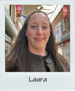 Polaroid of Laura- lady smiling with brown hair